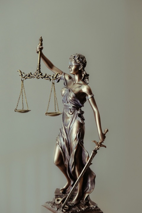 Lady Justice holding a balance and a sword.